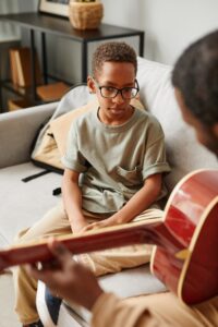Boy with Guitar Tutor